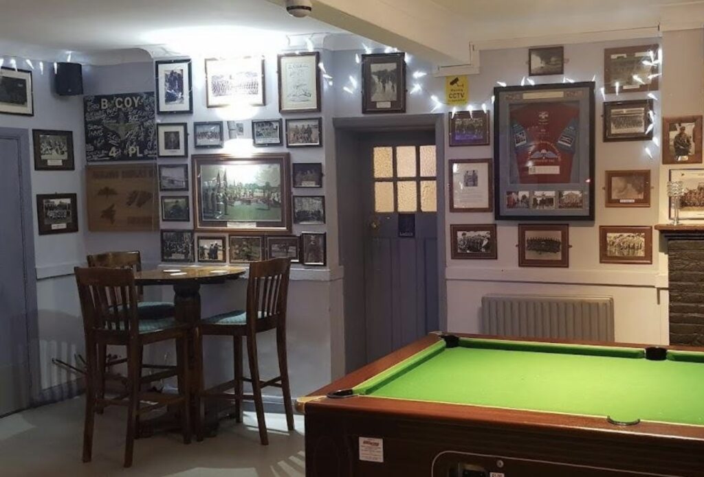 A picture of the inside of the Trafalgar public house with photos and memorabilia of the Parachute Regiment adorning the walls