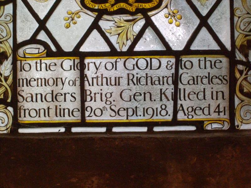 A close-up picture of the stained glass dedication to Arthur Sanders