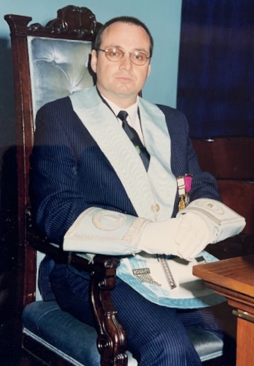 Mark Eyles-Thomas - Incredible Member Profile 11 A photograph of Mark Eyles-Thomas sitting at the Junior Warden’s pedestal when he was Junior Warden of Universal Lodge circa 1988