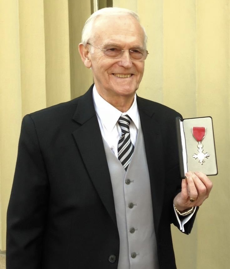Colin Gurnett - Incredible Member Profile 7 A picture of Colin Gurnett proudly displaying his MBE outside Buckingham Palace