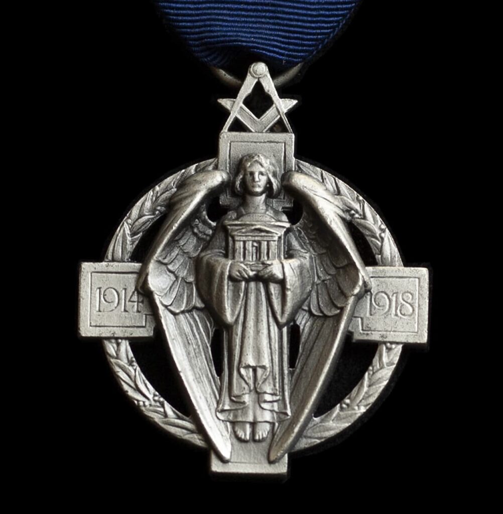 Incredible ‘The Ties that Bind’ 2 A picture of the Hall Stone Jewel. The jewel is in the form of a cross, symbolising Sacrifice, with a perfect square at the four ends, on the left and right, squares being the dates 1914-1918, the years in which the supreme sacrifice was made. Between them is the winged figure of peace.