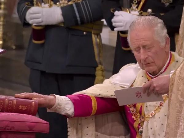 The Majestic and Sensational Coronation in Pictures - GSTK 6 A picture of King Charles III taking his oath with his right hand outstretched on the Holy Bible