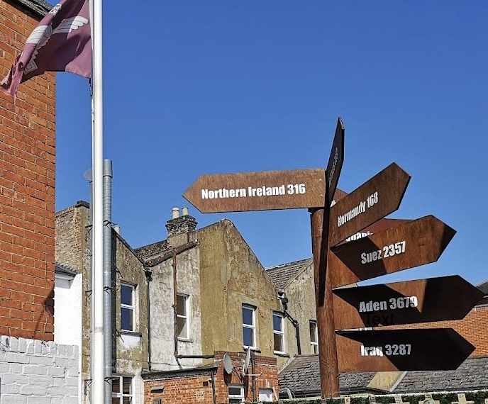 Powerful Part 6 Orders - Date for your diary 8 A photograph of the signpost in the rear outside area of the Trafalgar public house in Aldershot. The signpost indicates the direction of Northern Ireland three hundred and sixteen miles, Normandy one hundred and sixty eight miles, Suez, Aden, Iraq and other places that the paras have served