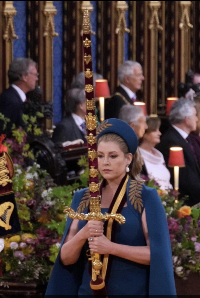 The Majestic and Sensational Coronation in Pictures - GSTK 4 A picture of a focused Penny Mordant, Royal Sword Bearer with Sword aloft
