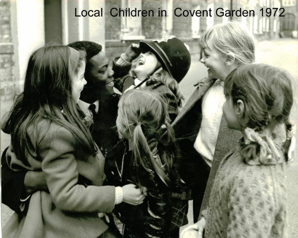 Norwell Roberts QPM - Incredible Member Profile 2 A black and white image of Constable Norwell Roberts with local children in Covent Garden in 1972